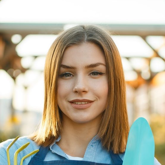 Female gardener from gardening company in plant shop